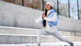 femme faisant du sport façon posture de yoga sur la neige